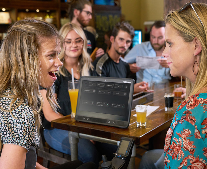 Tobii Dynavox TD Talk featured on a TD I-Series used by Delaina talking to her friend in a bar 